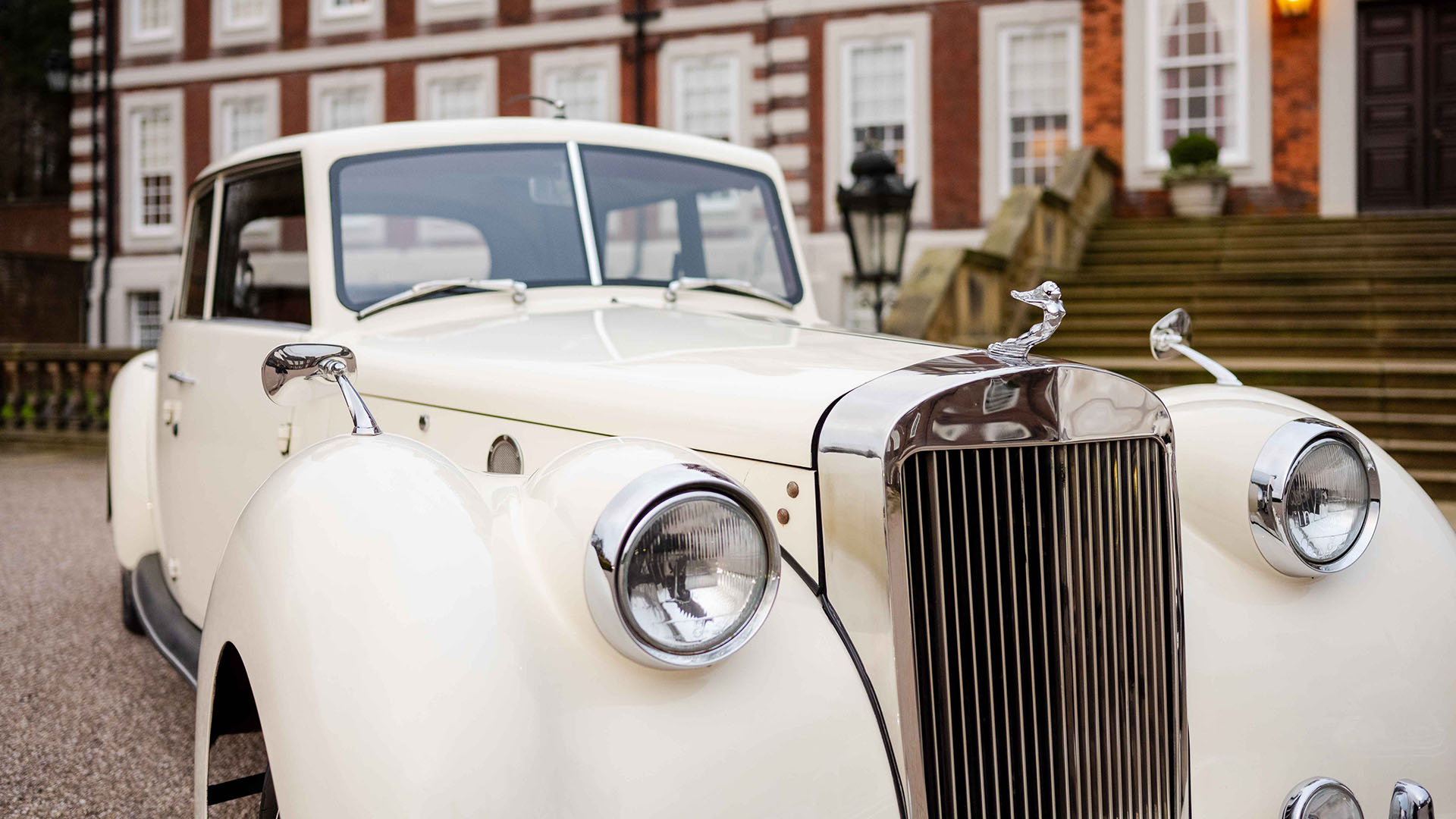 Close-up view of front grill and headlights on a cream vintage royale windsor