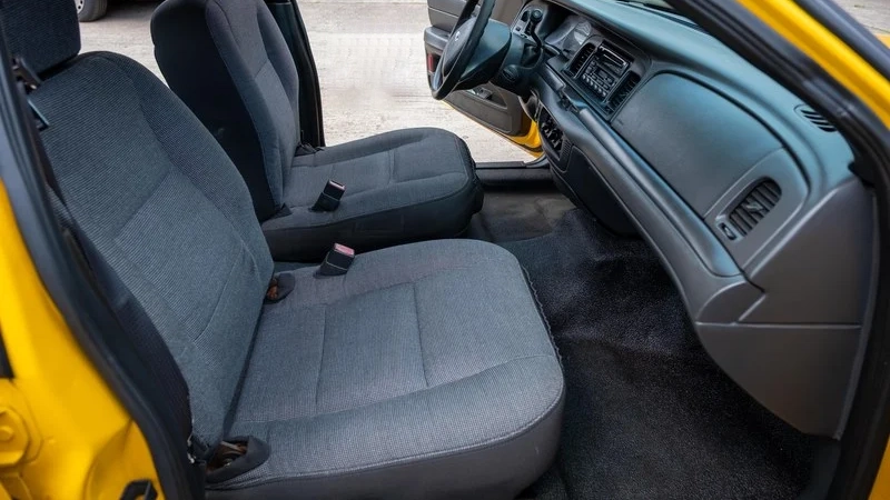 Front interior grey seats inside American Left-hand drive Yellow Cab