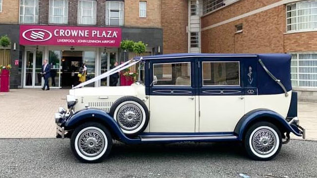 Left side view of Blue and Ivory Vintage Wedding Car parked in front of the Crowne Plaza in Liverpool