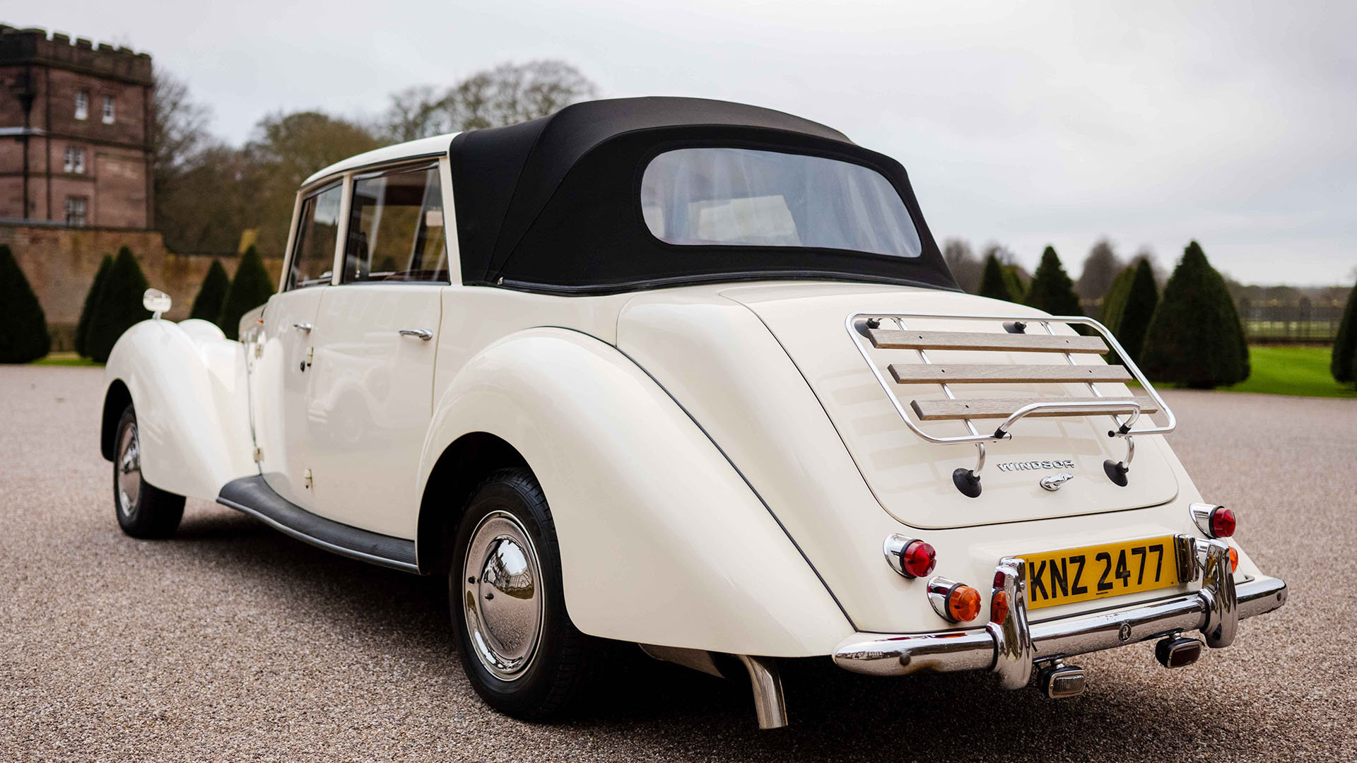 Rear view of Cream Vintage Royale Windsor with black soft top roof closed.