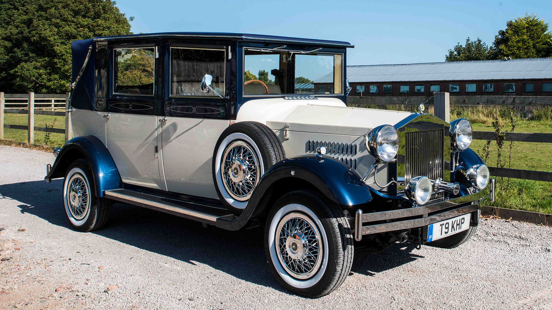 Ivory Vintage Car with Metallic Navy Blue wheel arches and semi-convertible soft top roof