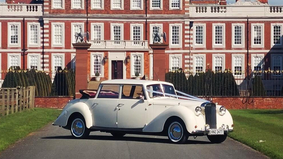 Cream Vintage Royale Windsor Wedding car with convertible rear soft top roof open.