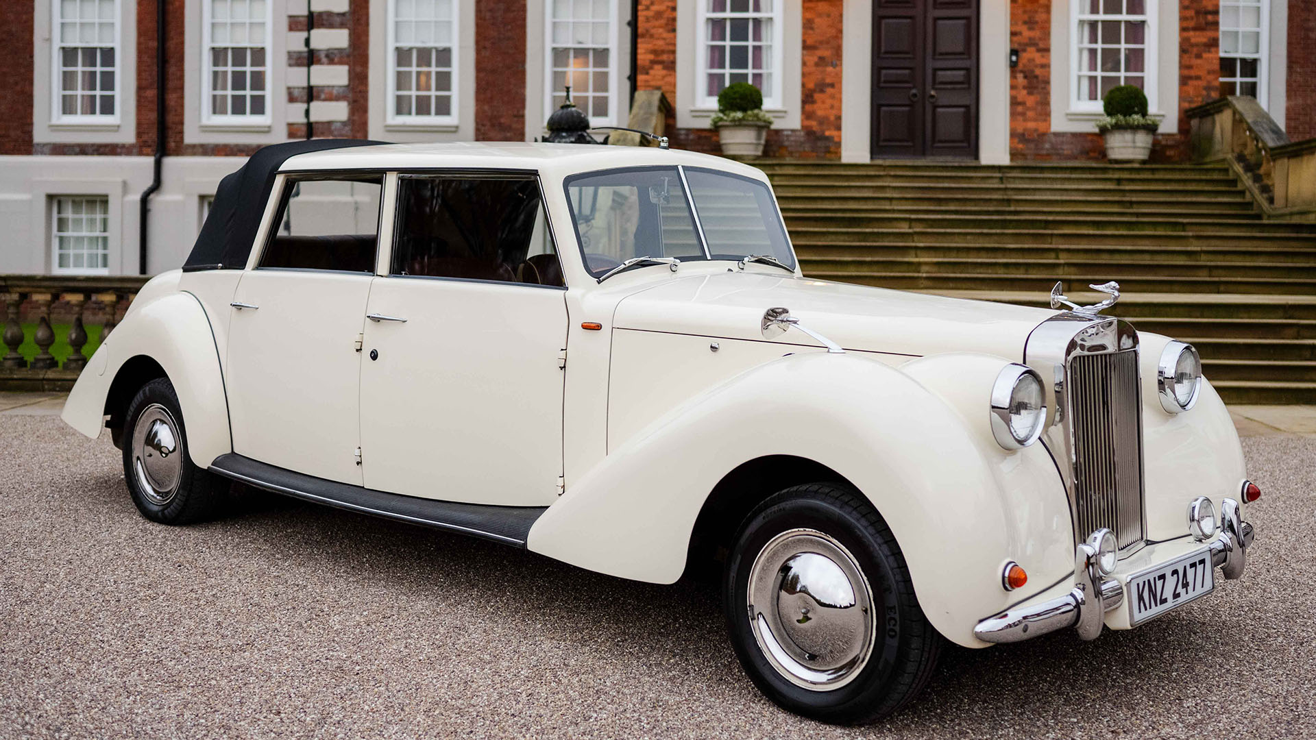 Cream Vintage Royale Windsor Wedding car with convertible rear soft top roof in black closed.