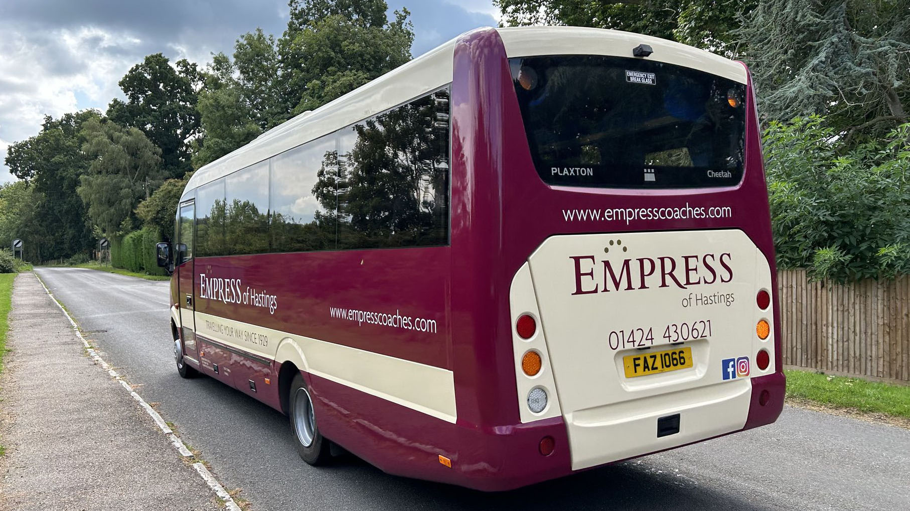 Left rear view of Modern 33-seats coach in Burgundy and Beige