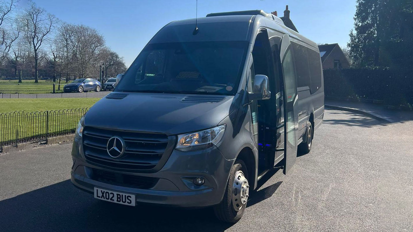 Front view of Grey Mercedes Mini Bus with passenger door open