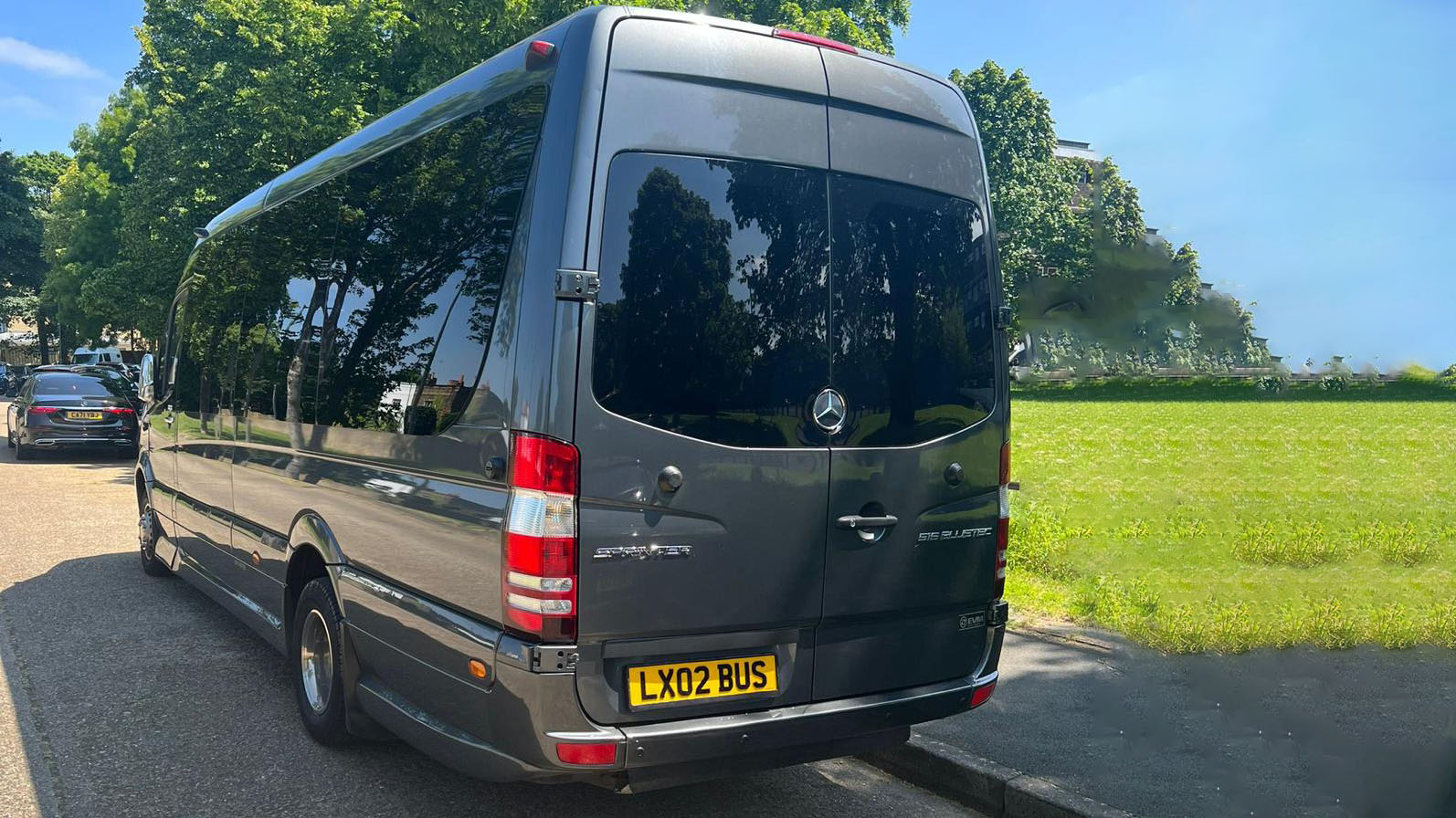 Rear view of Grey Mercedes Sprinter Mini Bus with privacy windows