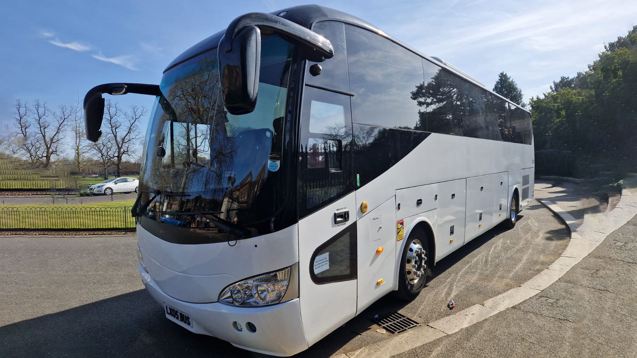 Modern White single-decker large Coach with privacy windows