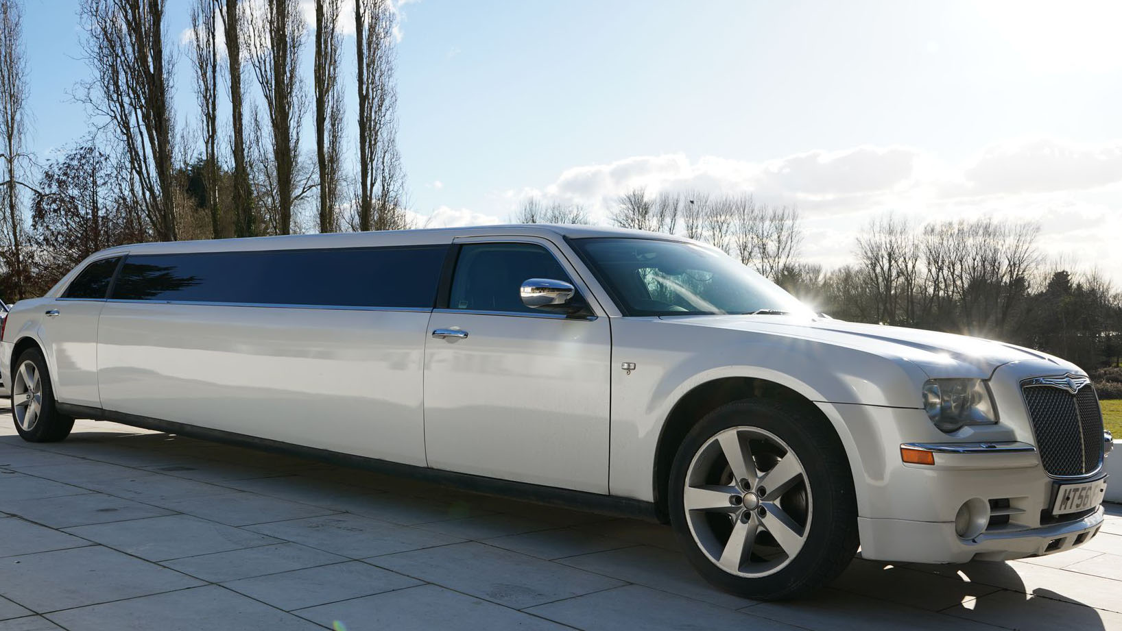 Right side view of Chrysler 300c stretched limousine in white