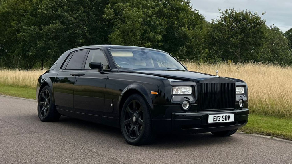 Black Rolls-Royce Phantom parked on the side of the road