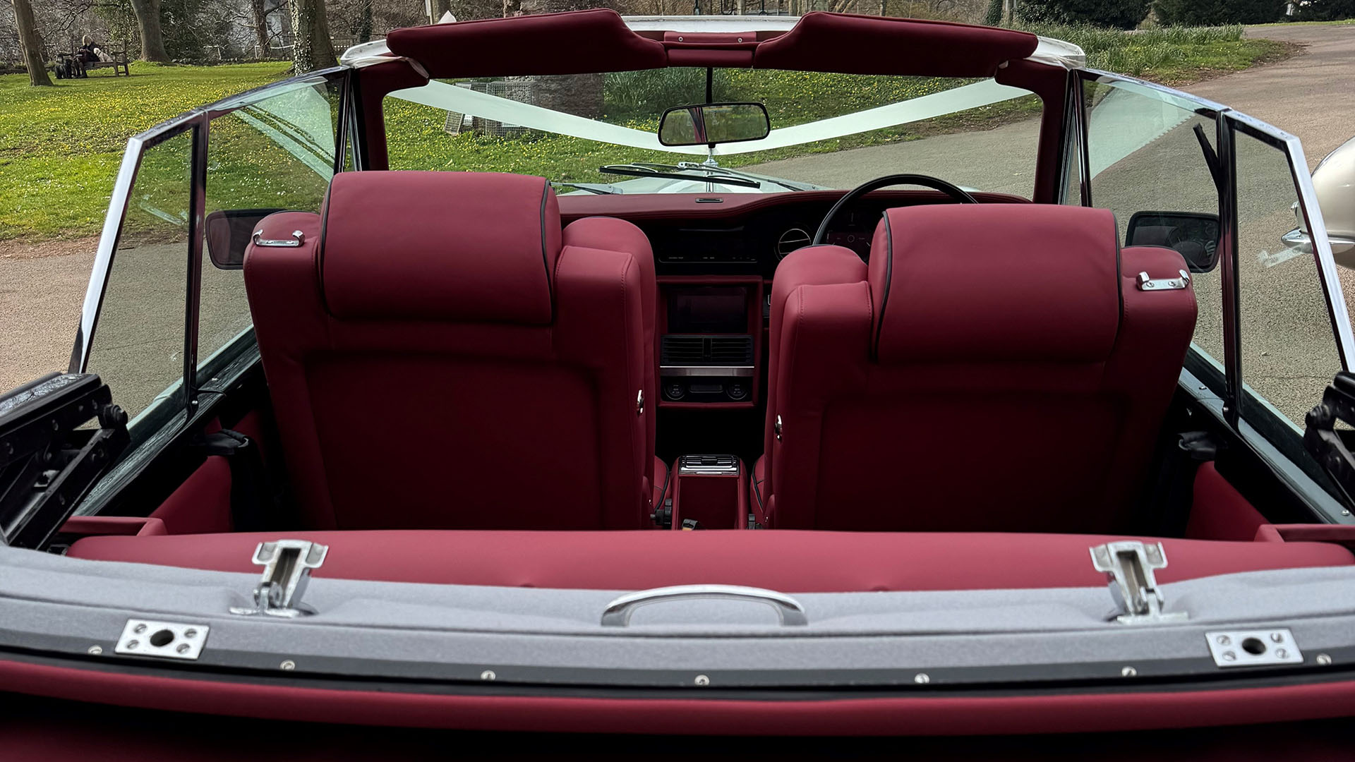 Convertible roof open on white Rolls-Royce corniche