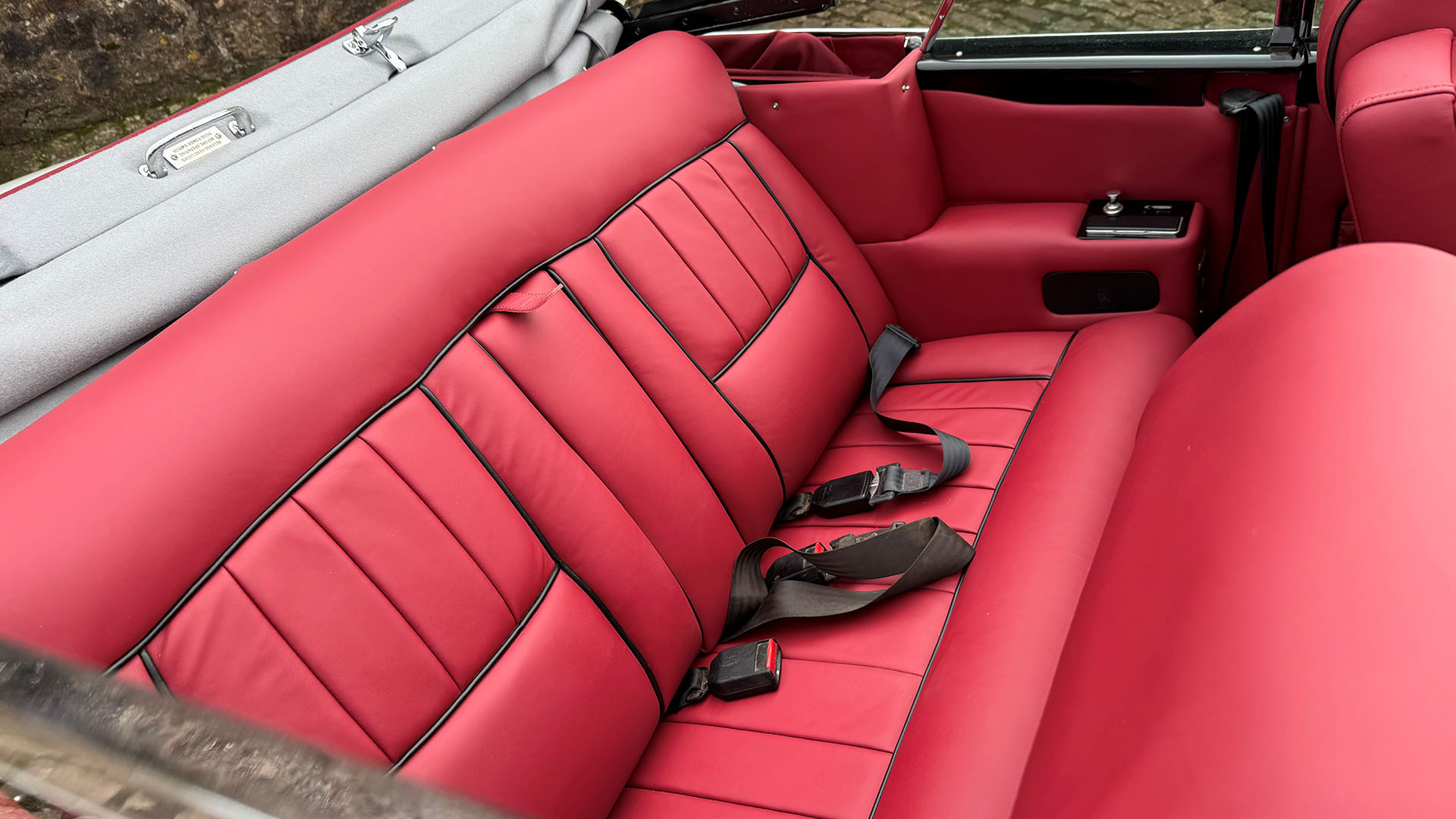 Rear interior burgundy leather seat inside convertible Classic Rolls-Royce Corniche