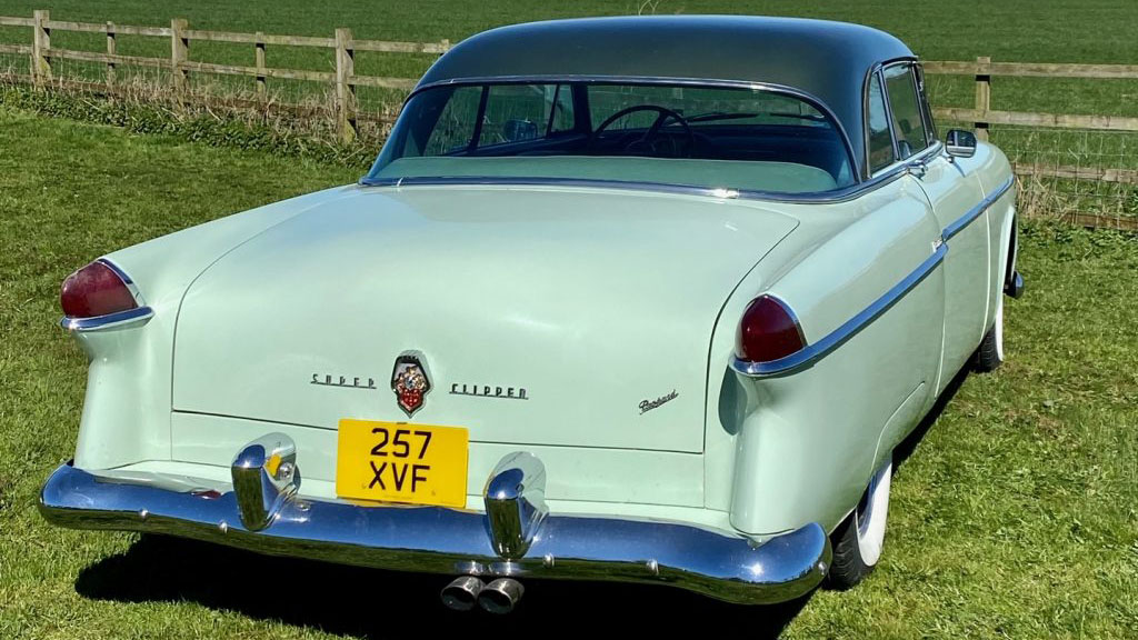 Rear view of an American Packard in pale green with large rear chrome bumper