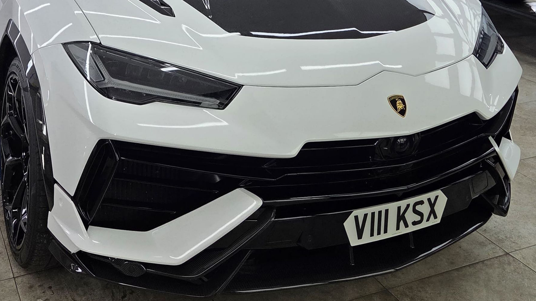 Front black bumper view of White Lamborghini Urus