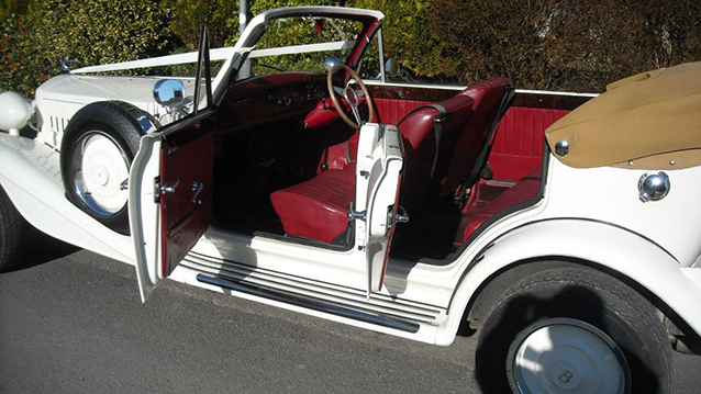 burgundy leather interior of white Beauford 4 Door Convertible