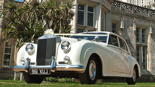 Left front side Rolls-Classic Royce Silver Cloud at Highcliffe Castle with white Wedding Ribbons