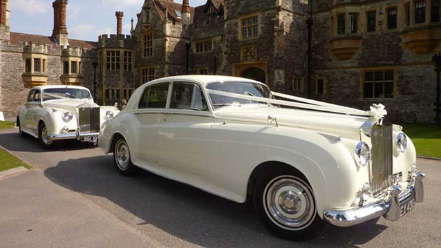 Two identical Rolls-Royce Silver Cloud waiting for Bride and Groom at Rhinefield House Hotel in the New Forest