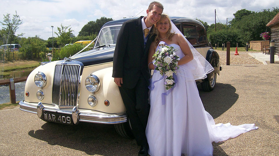Armstrong-Siddeley Limousine with bride and groom in front of the vehicle