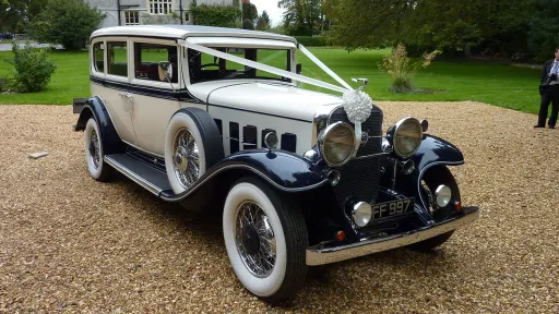 Vintage Cadillac Wedding car decorated with White ribbons