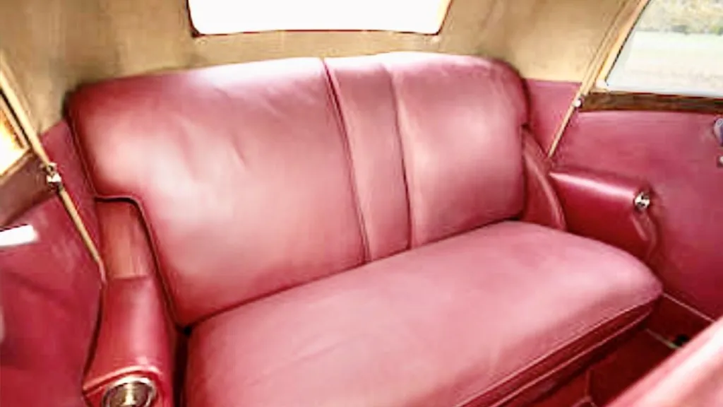 Burgundy leather seats inside a vintage Rolls-Royce Phantom