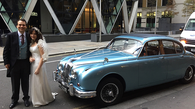 Bride and groom in front of classic Daimler 250 V8
