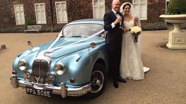 Metallic Blue Daimler 250 V8 with Bride and groom in front of the car
