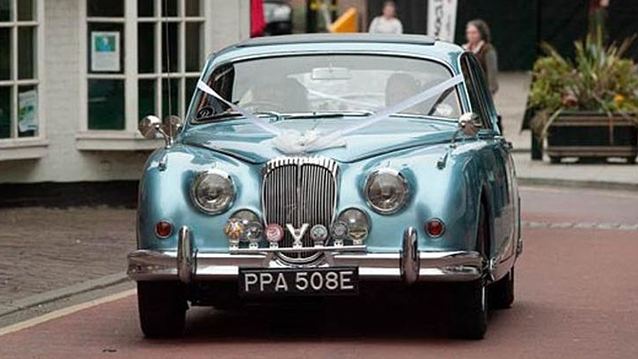 Front view of Daimler 250 V8 with white ribbons
