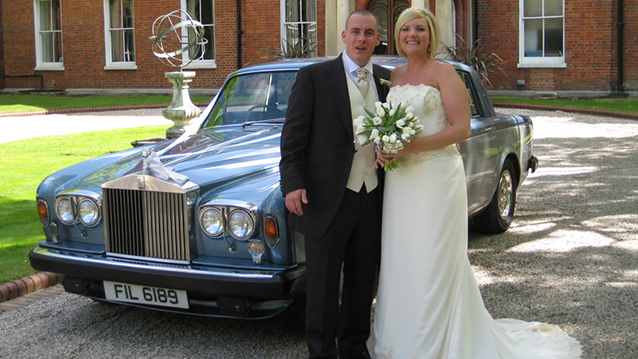 Bride and Groom stands in front of a classic Rolls-Royce Silver Shadow II