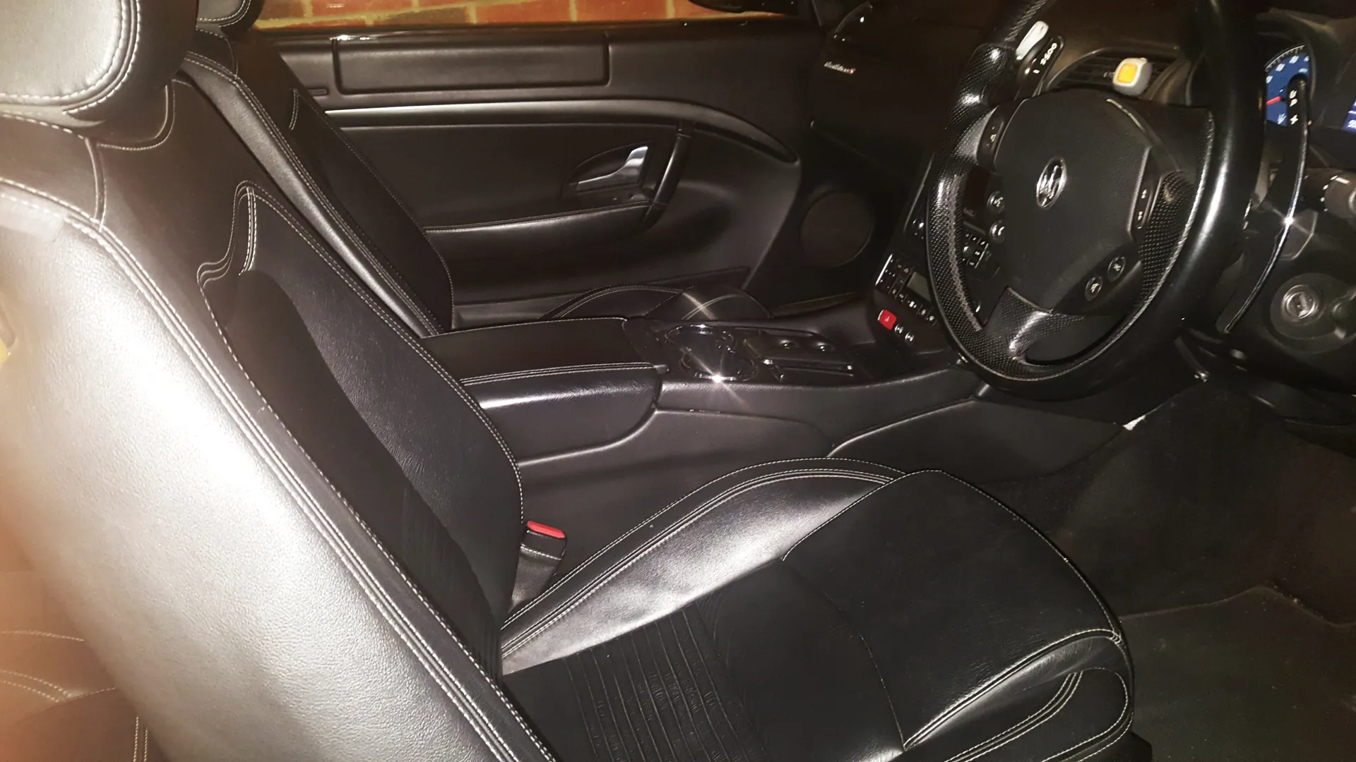 Driver Seating area in Maserati with black leather interior