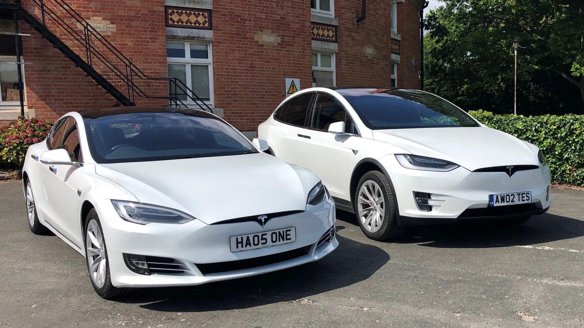 Pair of Tesla X and a Tesla S parked side by side.