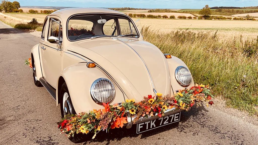 Volkswagen Beetle front view with flower garland