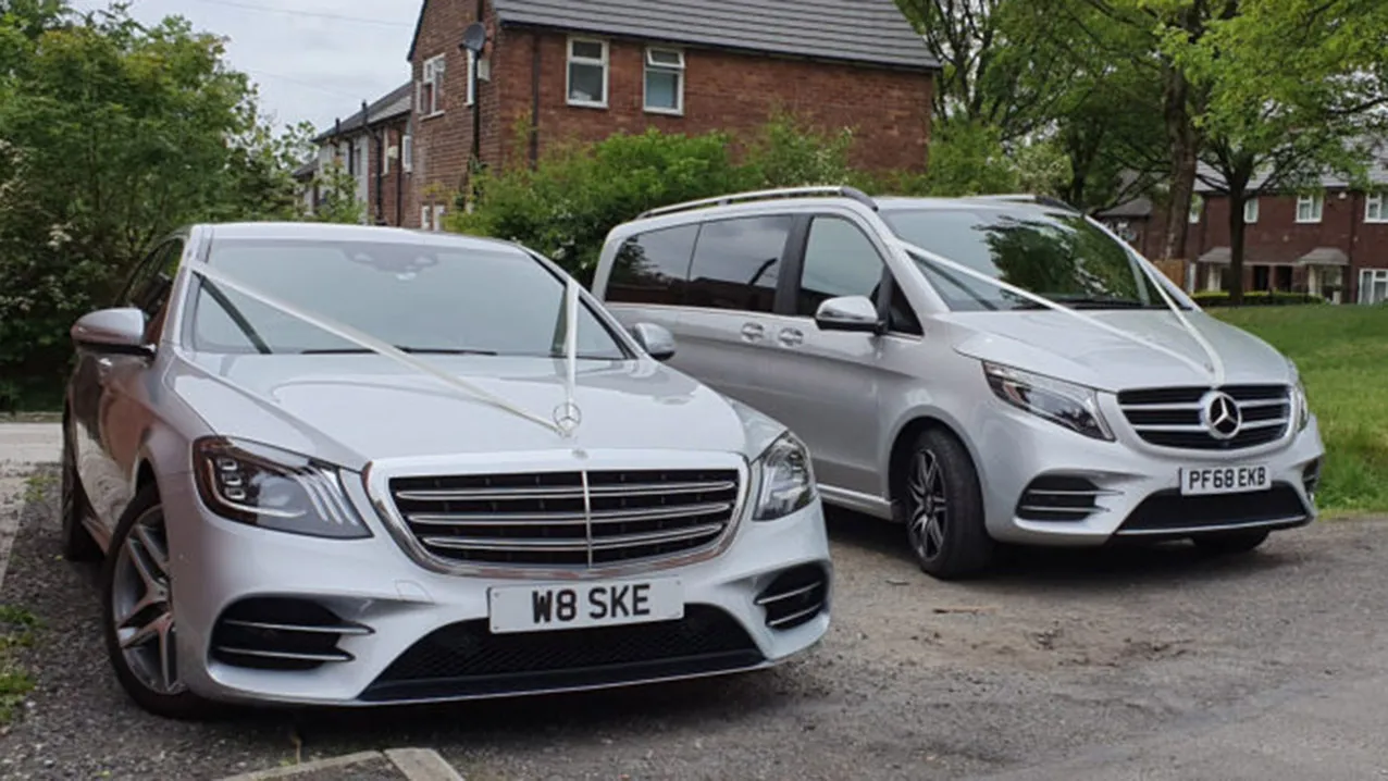 Two Mercedes Wedding Cars in silver decorated with ribbons