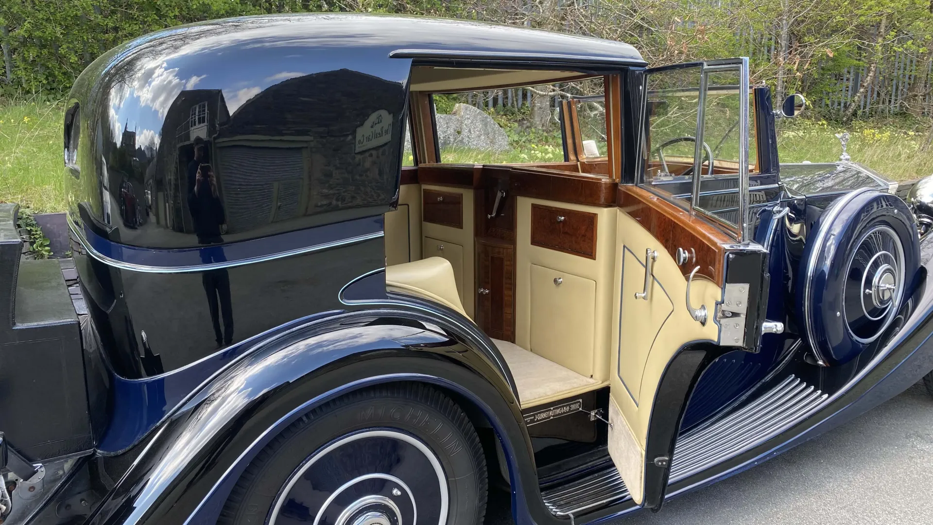 Rear Side view of Rolls-Royce Sedanca de Ville in Dark Blue with door open showing cream interior and wood on doors