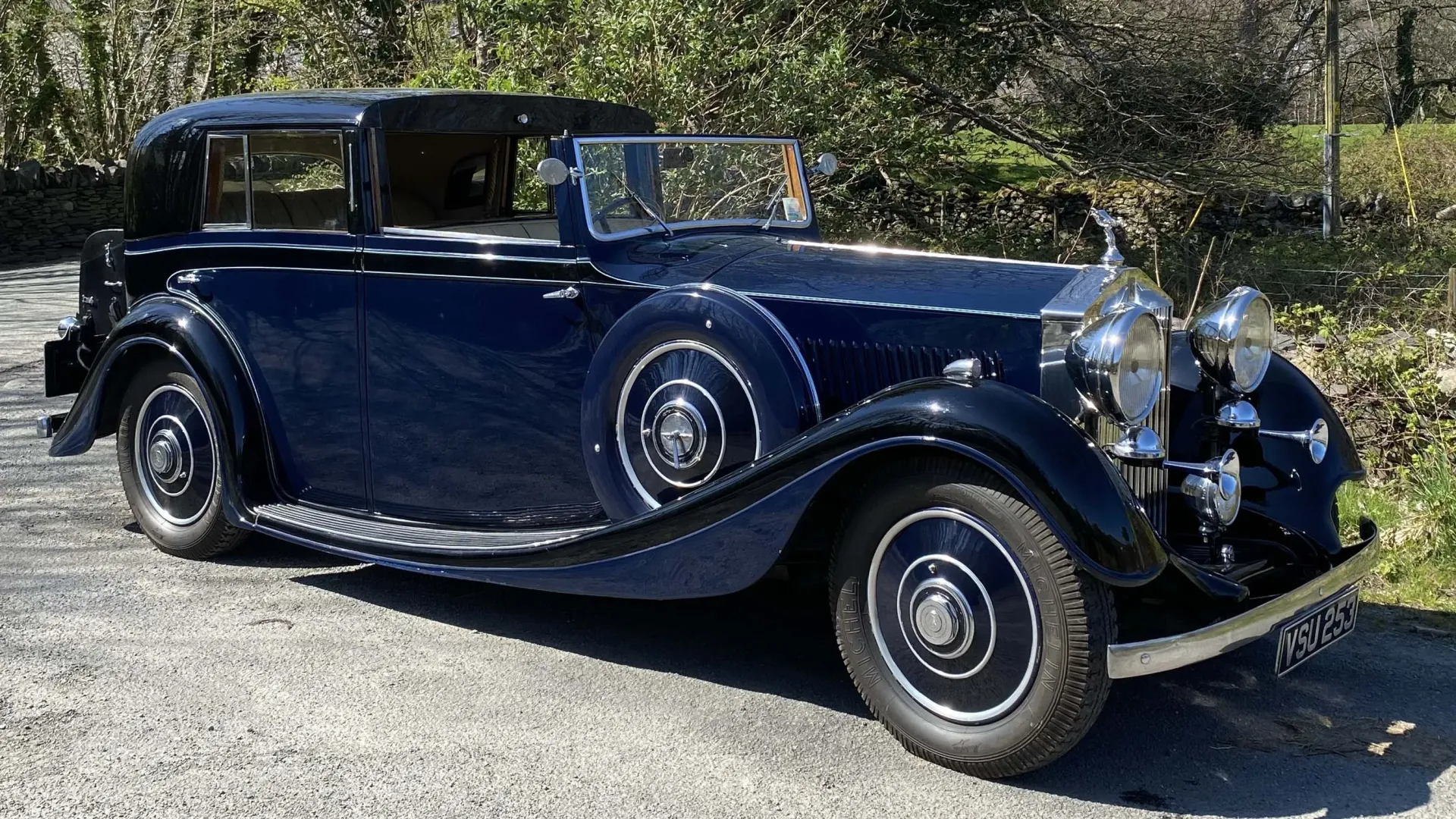 Right Side view of Vintage Rolls-Royce Sedanca de Ville in Blue showing the mounted spare wheel on car's skirt