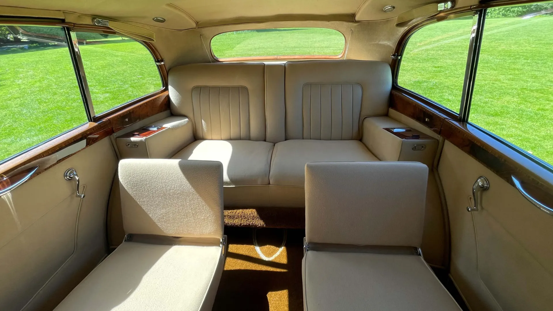 rear cabin of Rolls-Royce silver Wraith LWB with casual seats up showing seats for up to 5 passengers