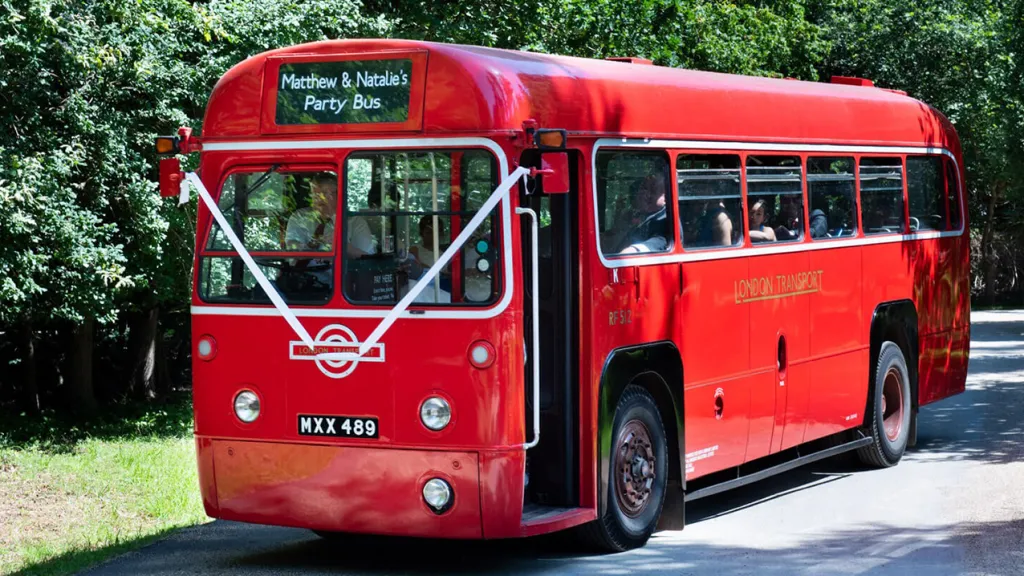 Red sginle Decker Bus with Wedding Ribbons