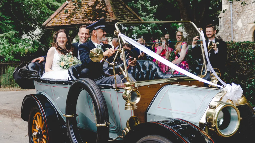 Oakland Model 40 Tourer with chauffeur driving the vehicle and bride and groom seating in the rear seats